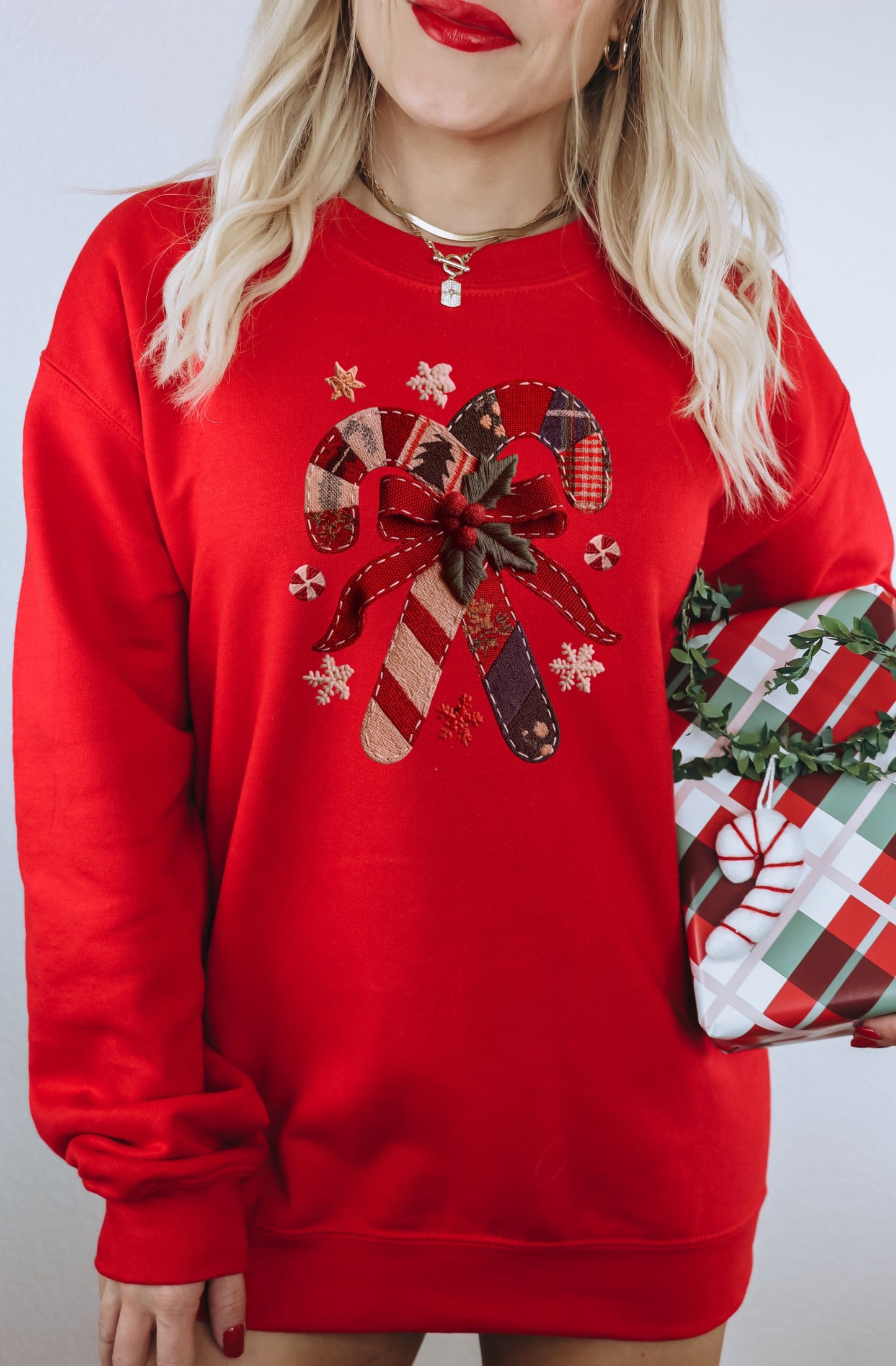 Festive Red Sweatshirt with Embroidered Candy Cane Design